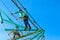 Boy child steps on wooden boards on the obstacle course in an amusement park, outdoor activities, rock climbing, danger, training,