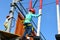 Boy child steps on wooden boards on the obstacle course in an amusement park, outdoor activities, rock climbing, danger, training,