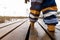 Boy child walking on a wooden pathway in a natural park. Close up of feet. Healthy active living concept