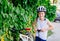 Boy child in white bicycle helmet inflating tire