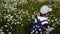 Boy a child in a white cap and a blue backpack with stars runs