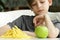 Boy chooses fruit or fast food