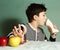 Boy choosing junk food roll refuse from apple