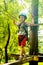 boy at climbing activity in high wire forest park