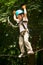 boy at climbing activity in high wire forest park