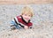 Boy climbing a rocky ledge