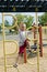 Boy Climbing Up Jungle Gym On Playscape