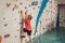 Boy at the climbing wall without a helmet, danger at the climbing wall