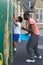 Boy On Climbing Wall In School Physical Education Class