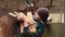 A boy close-up straightens the firewood in an armful with his hands.