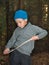 Boy closeup knife cuts a stick