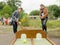 Boy with a club plays children`s golf with obstacles in a summer park