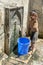 A boy collecting water from a fountain at the entrance to the Fez medina in Morocco.