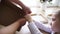 The boy collects a packing cardboard box with his hands, his mother helps him