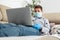 Boy with computer does his homework during a coronavirus quarantine. concept of online education.