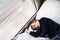 Boy confined at home by the coronavirus crisis in Spain, looks bored out the window without being able to leave home