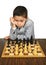 Boy contemplating chess move