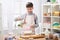 Boy cooking in home kitchen, making dough, healthy and homemade food concept