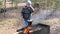 Boy cooks food on the fire in the grill. Country rest.