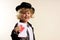Boy in costume, showing a drawing of a heart