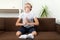 Boy on the couch prays to God next to book. Child is preparing for test exam