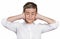 Boy covering ears with hands, doesn\'t want to hear loud noise, ignoring conversation