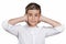 Boy covering ears with hands, doesn\'t want to hear loud noise, ignoring conversation