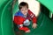 Boy crawling through a playground tunnel