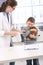 Boy cuddling with pet rabbit at vet office