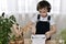 The boy, cultivates soil in a flower pot rake, is engaged in the planting of hyacinths.