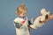 Boy cure toy sheep with vaccine on blue background