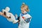 Boy cure toy sheep with vaccine on blue background