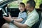 Boy with dad learn driving car
