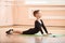 Boy dancer doing exercise at ballet class