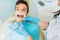 Boy in a dental cabinet, caries removal procedure