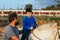 Boy with a disability riding a horse during an assisted equine therapy session.