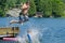 Boy dive bombing friend off dock into lake