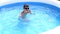 Boy dives in swimming pool with swimming glasses. boy swims in the pool.