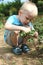 The boy does some gardening