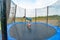 Boy does a somersault jumping on a trampoline in a sports extreme park