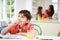 Boy Doing Homework As Mother And Daughter