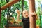 Boy doing pull ups on the rope playground outdoors. Healthy lifestyle concept. Close-up of a boy on a rope climbing net