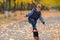 Boy doing skateboard trick in park.