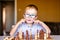 Boy with down syndrome with big glasses playing chess