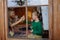 Boy with Down syndrome with his grandmother cleaning window at home.