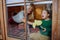 Boy with Down syndrome with his grandmother cleaning window at home.