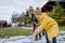 Boy with Down syndrome with his mother clearing snow from path with shovel in front of house.