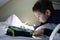 Boy drawing on top shelf of train compartment