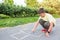 The boy draws on the pavement with chalk in the park. Games in the park