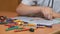 Boy draws pictures using color chalks and pencils